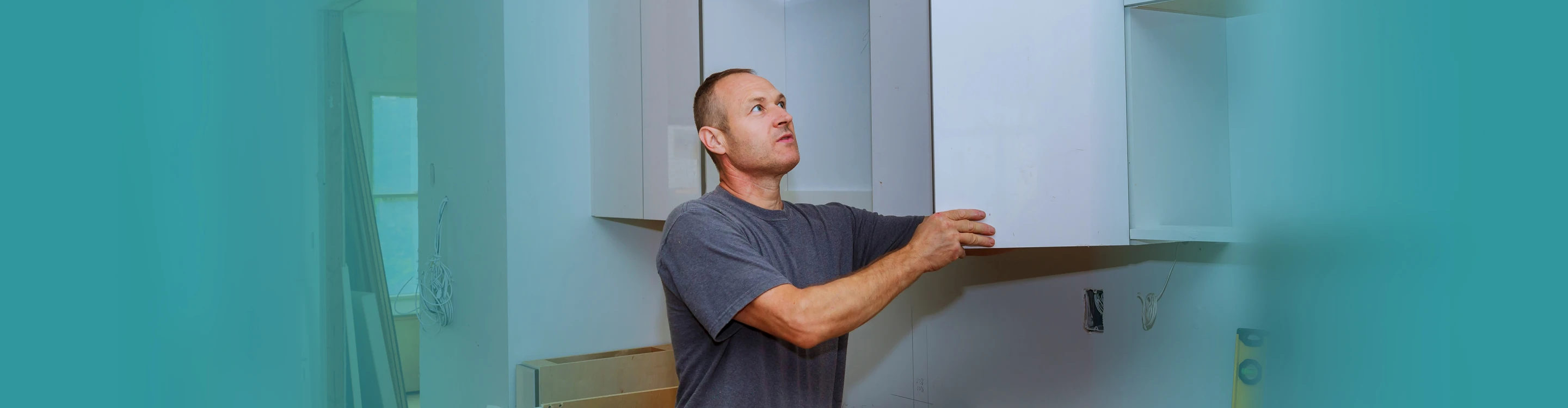 carpenter hanging cabinets