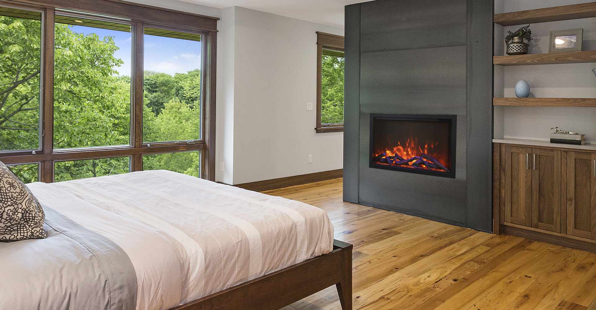Cozy bedroom with hardwood floors and fireplace. 