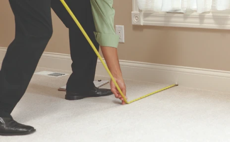 In Home Consultant Measuring Carpet